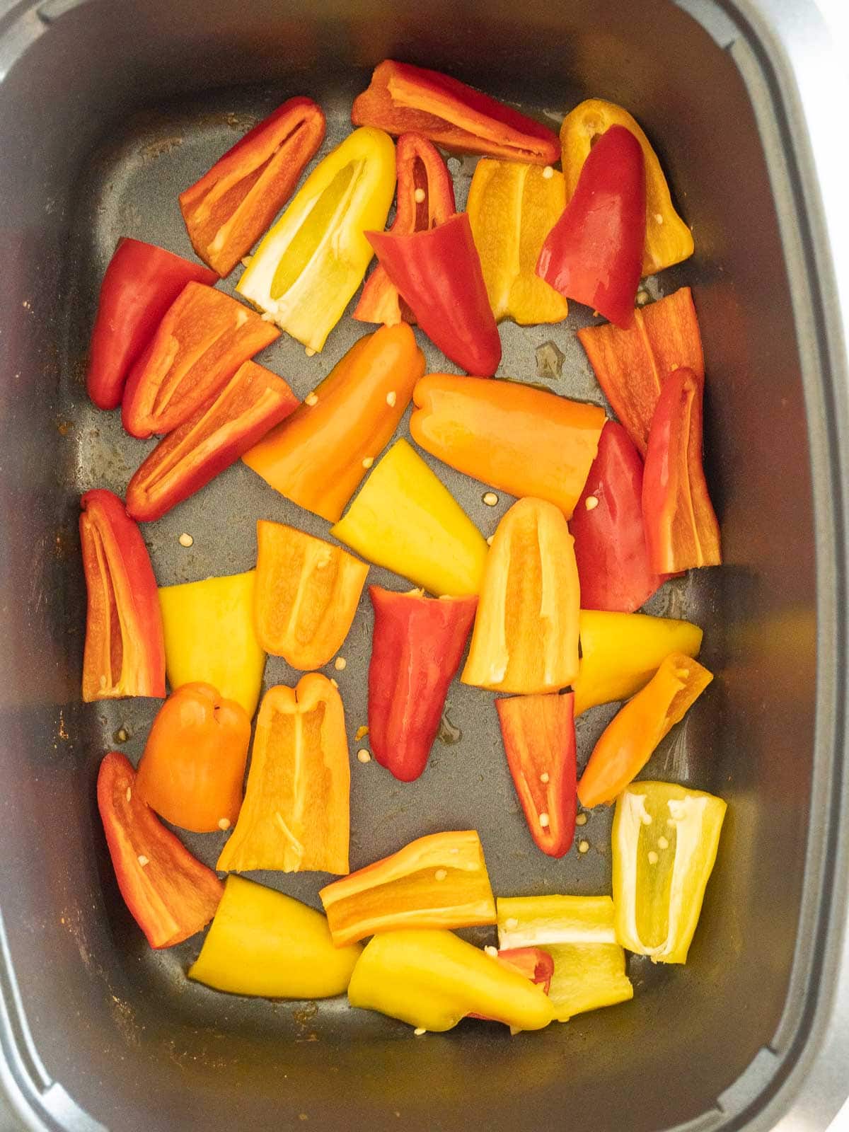 Sliced mini peppers in slow cooker.