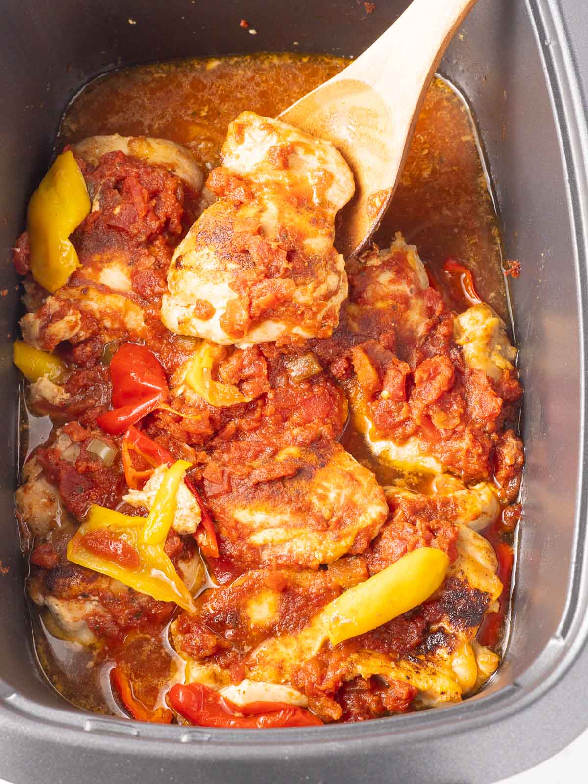 Salsa chicken and peppers cooking in slow cooker.