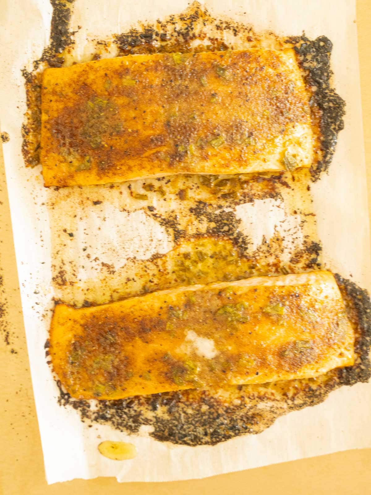 Blackened salmon fillets baked in the oven.