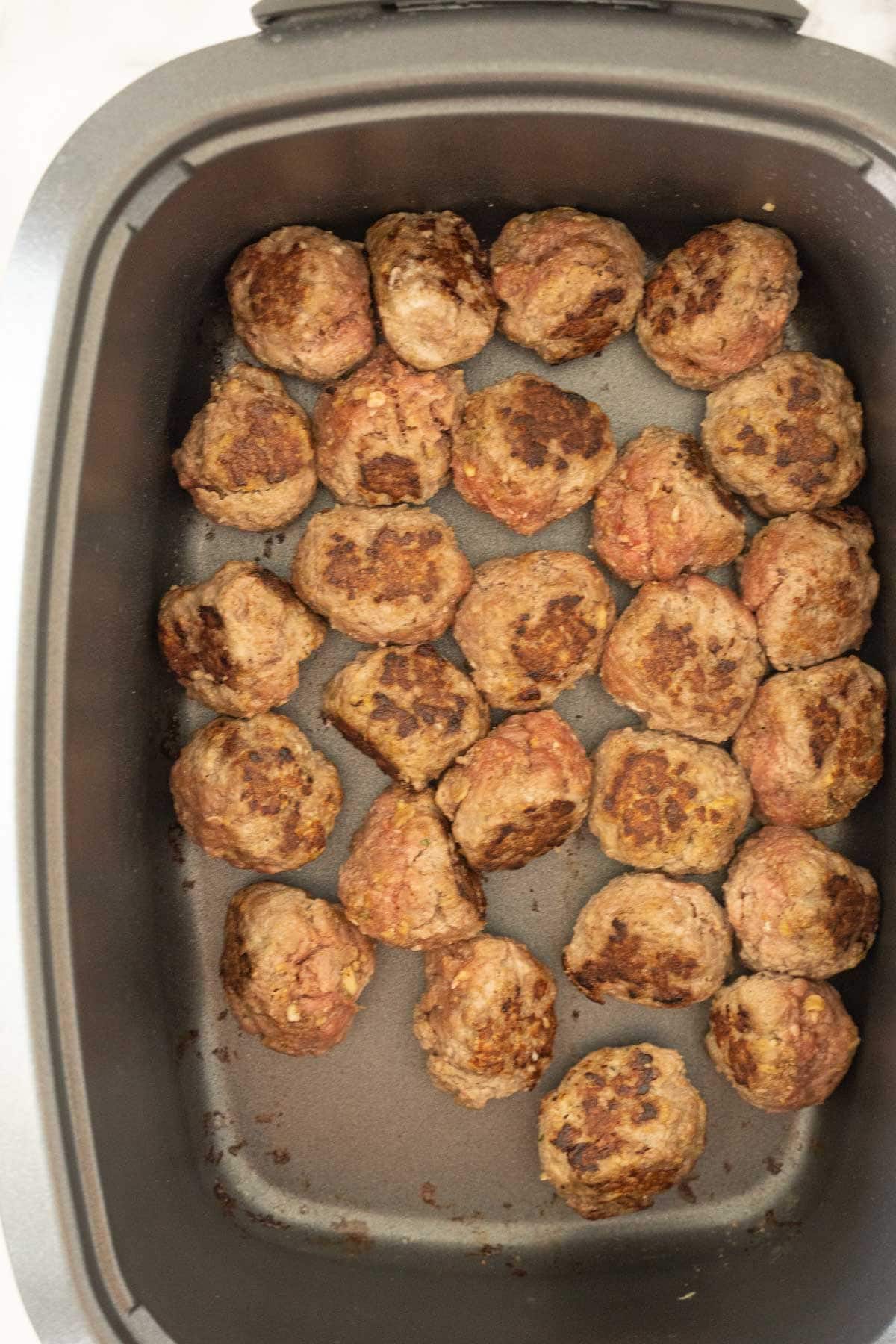 Browned meatballs in slow cooker.