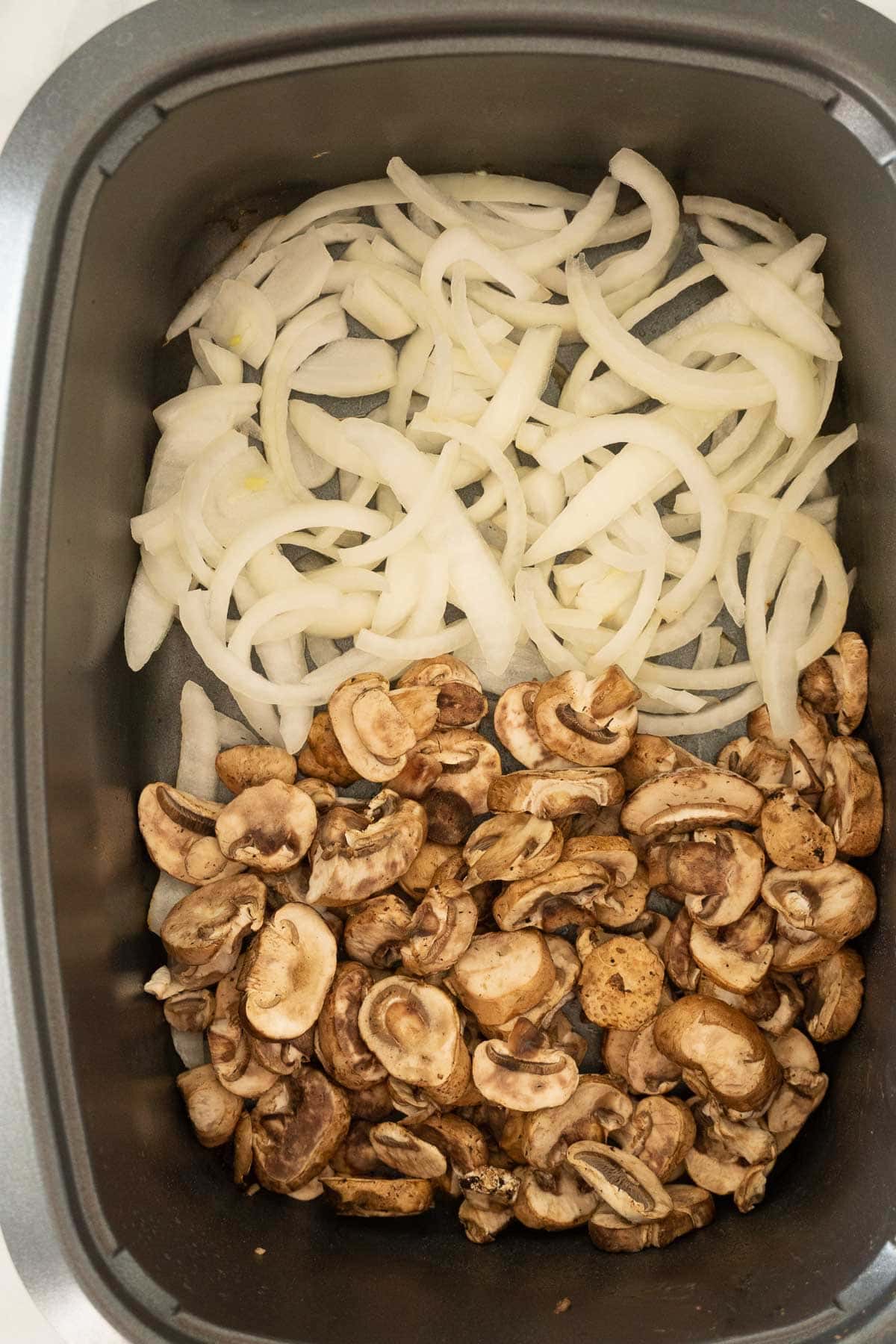 Browned mushrooms and onions in slow cooker.