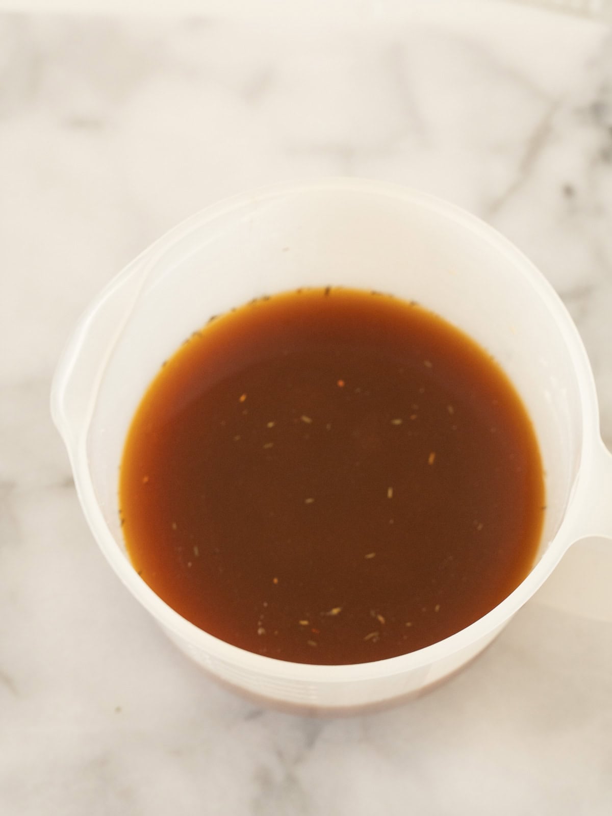 Brown gravy in large measuring bowl.