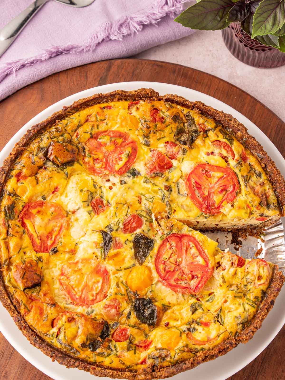 Tomato and Basil Quiche on wooden board.