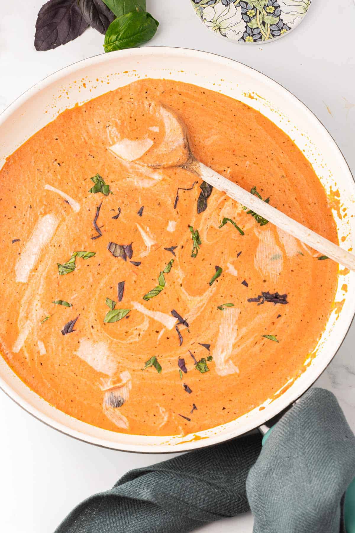 Italian Pink Sauce in large skillet with wooden spoon.