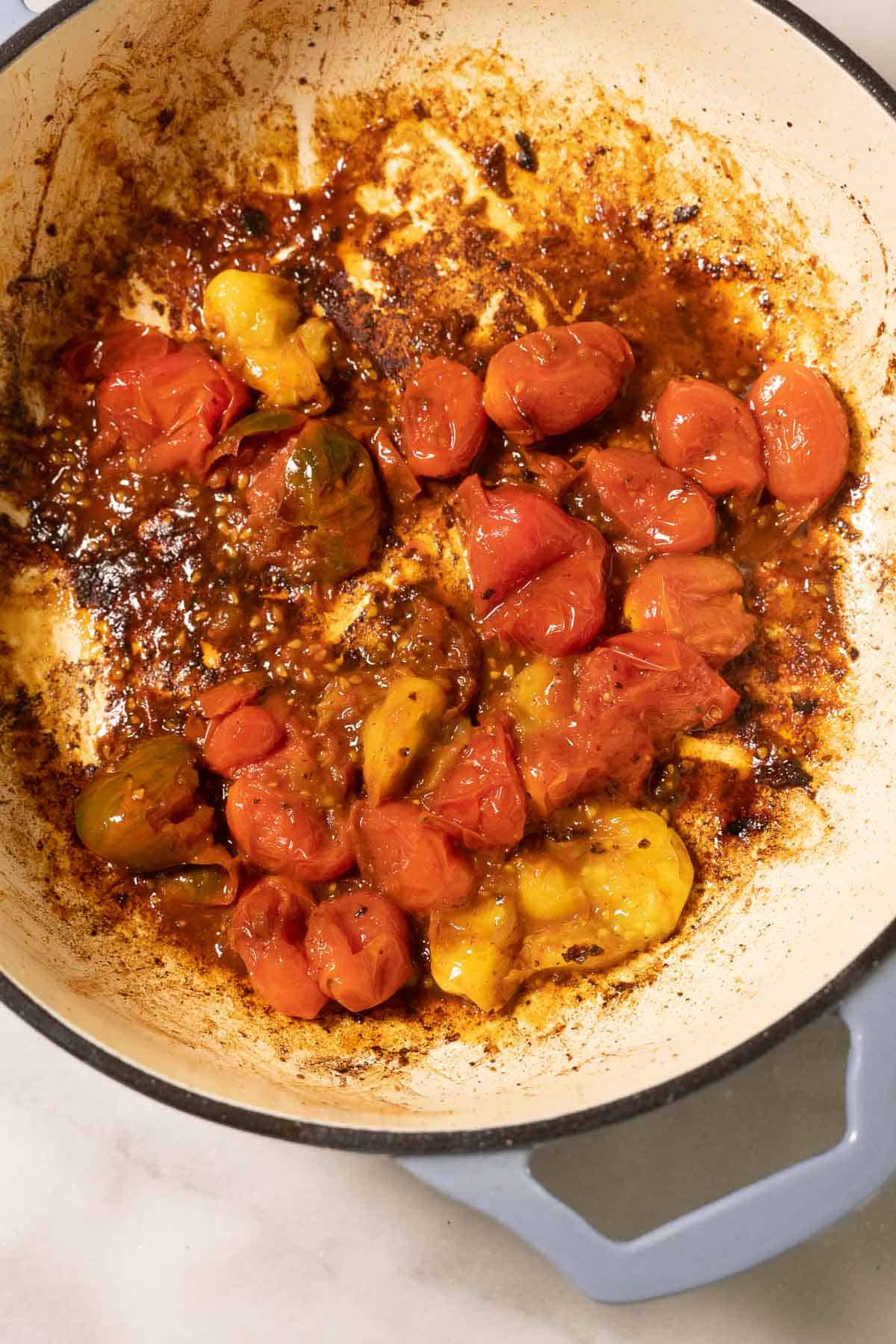 Burst cherry tomatoes in pot,