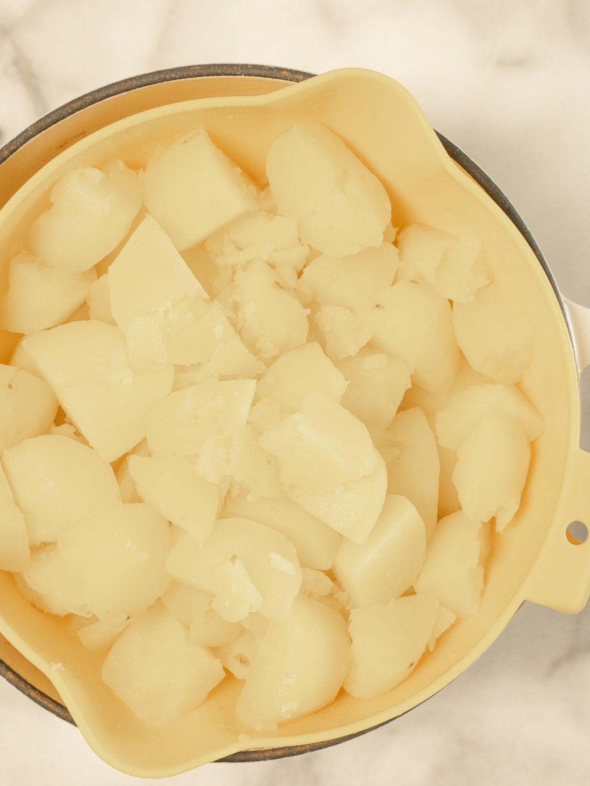 Cook potatoes in a strainer.