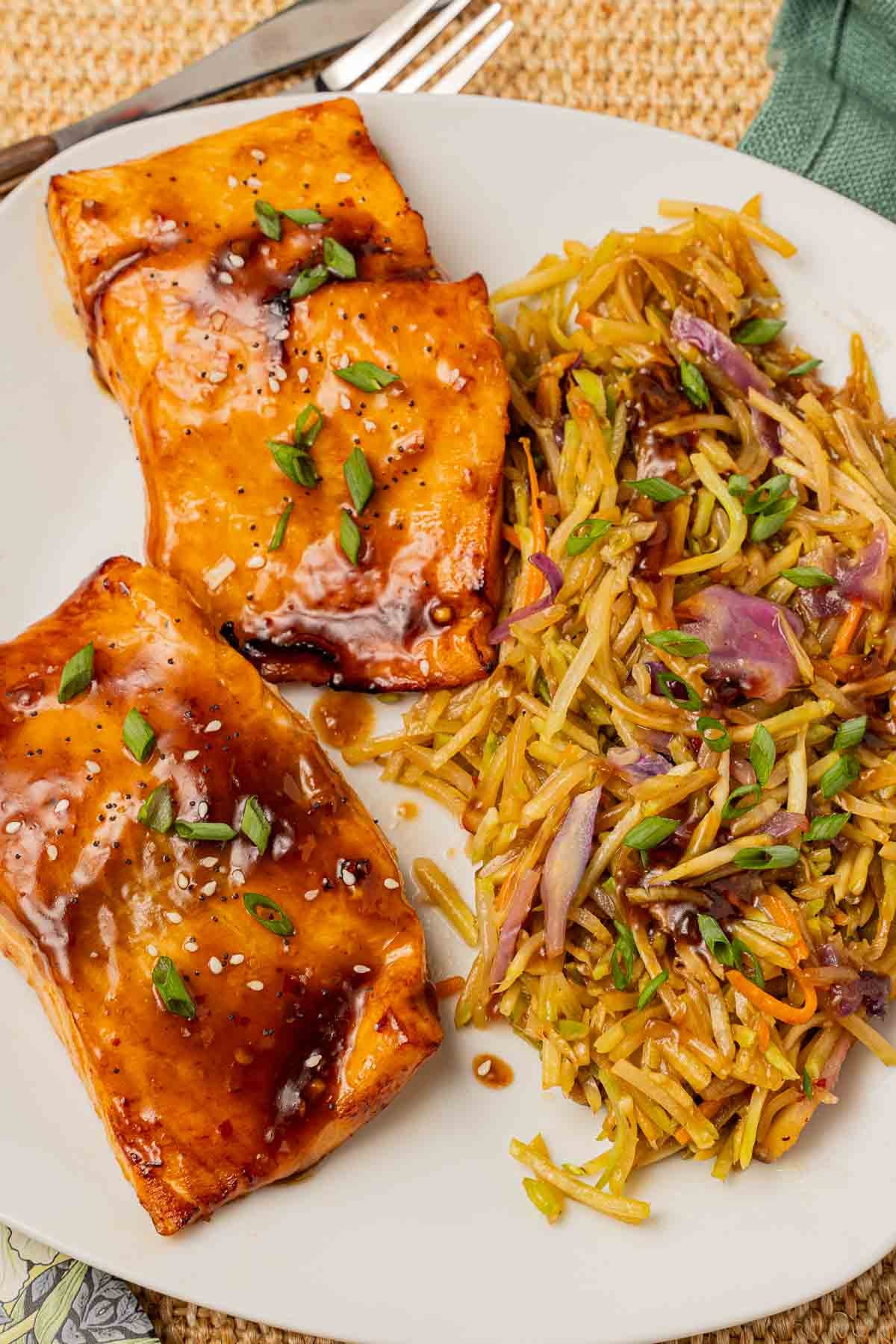 Air Fryer Teriyaki Salmon fillets with broccoli slaw on plate.