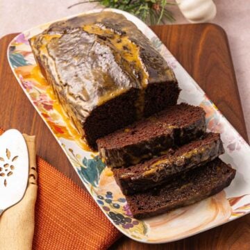 Chocolate Pumpkin Bread with glaze on platter.