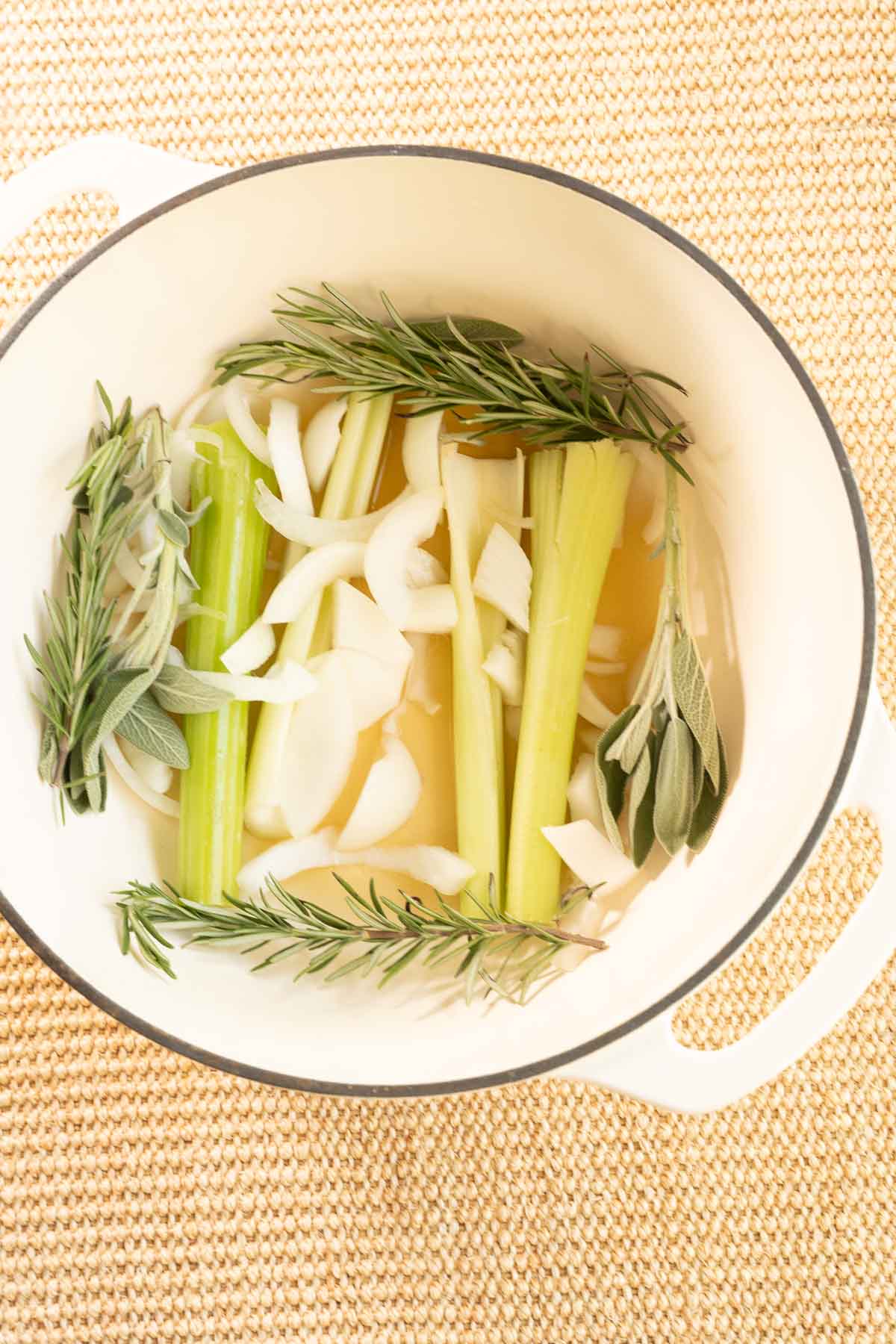 Celery, onions, rosemary and sage in dutch oven.