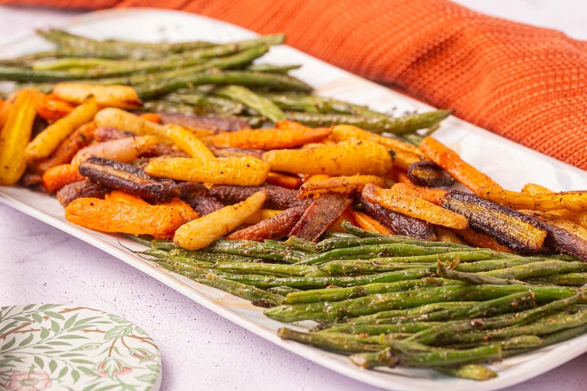 Roasted carrots and green beans on platter.