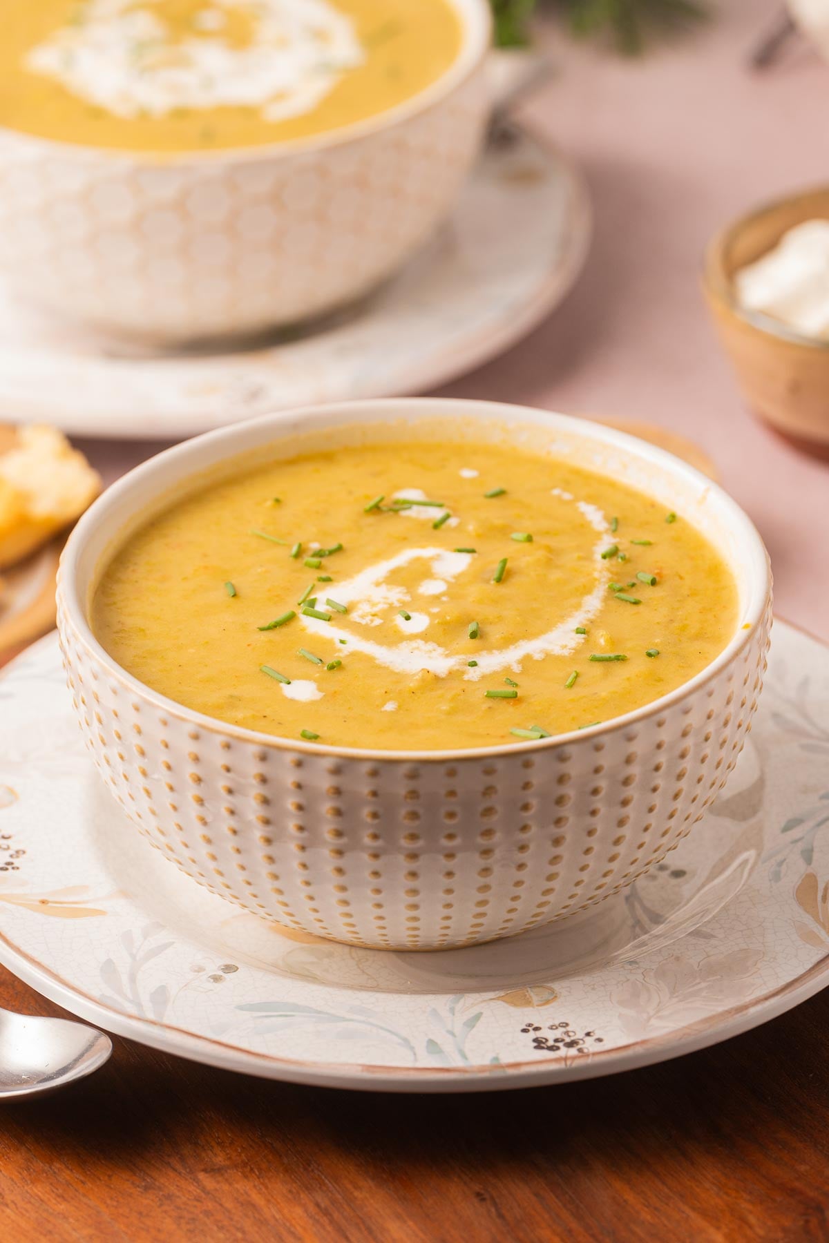 Bowl of Cream of Asparagus and Potato Soup on plate.