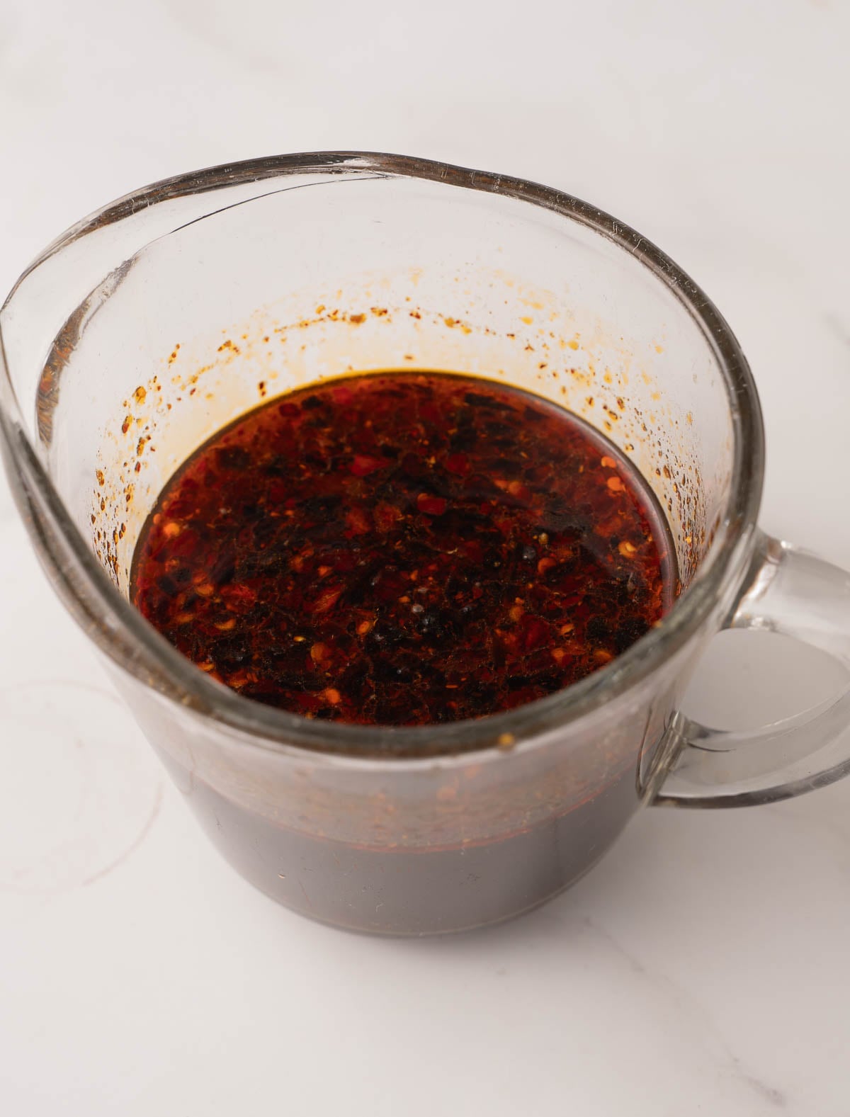 Thai Basil Sauce in glass measuring cup.