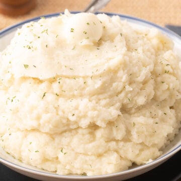 Garlic Mashed Russet Potatoes in bowl with spoon,