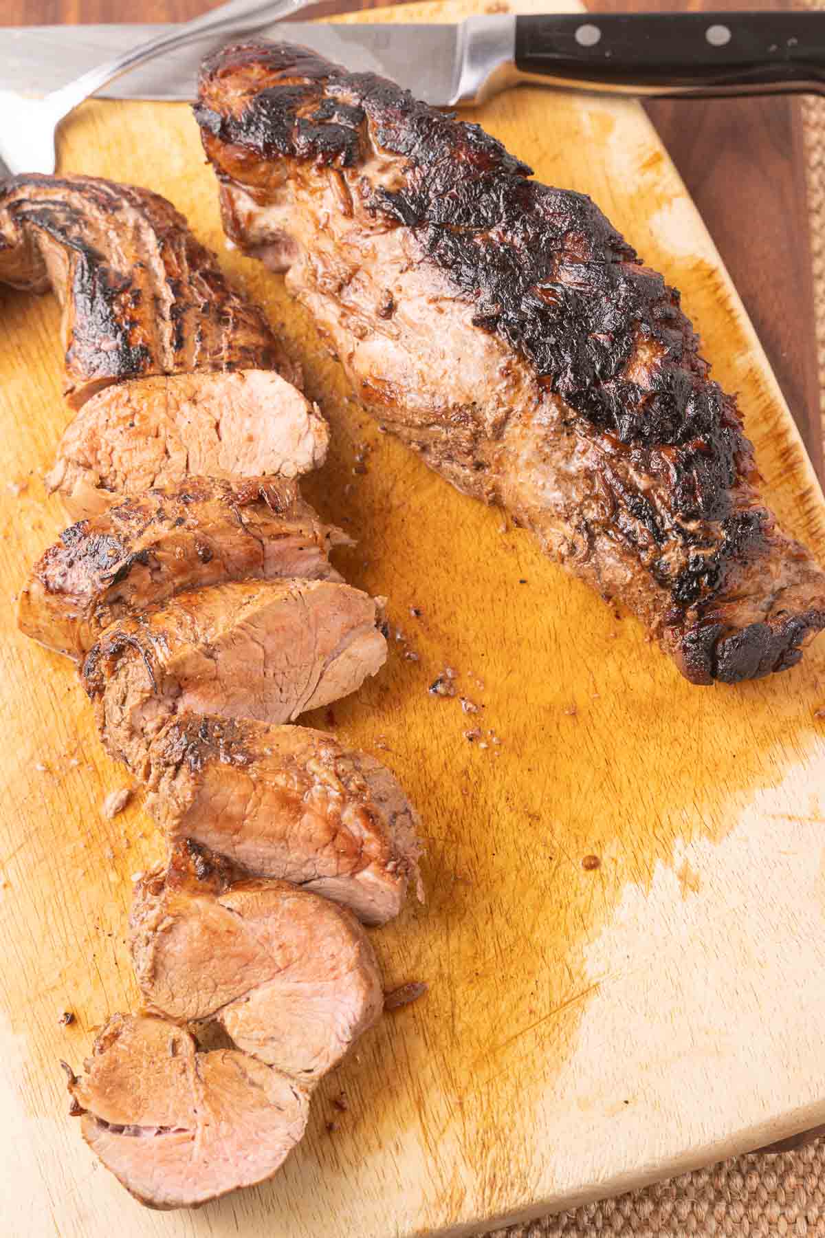 Pork tenderloin on cutting board.