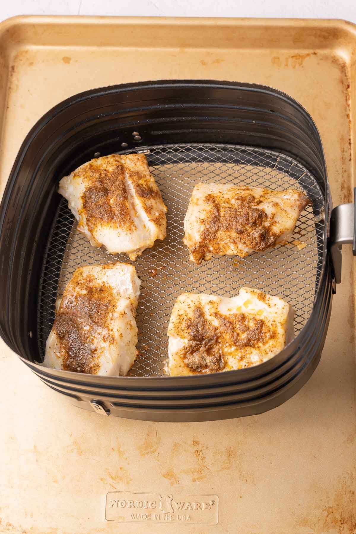 Haddock in air fryer basket.

