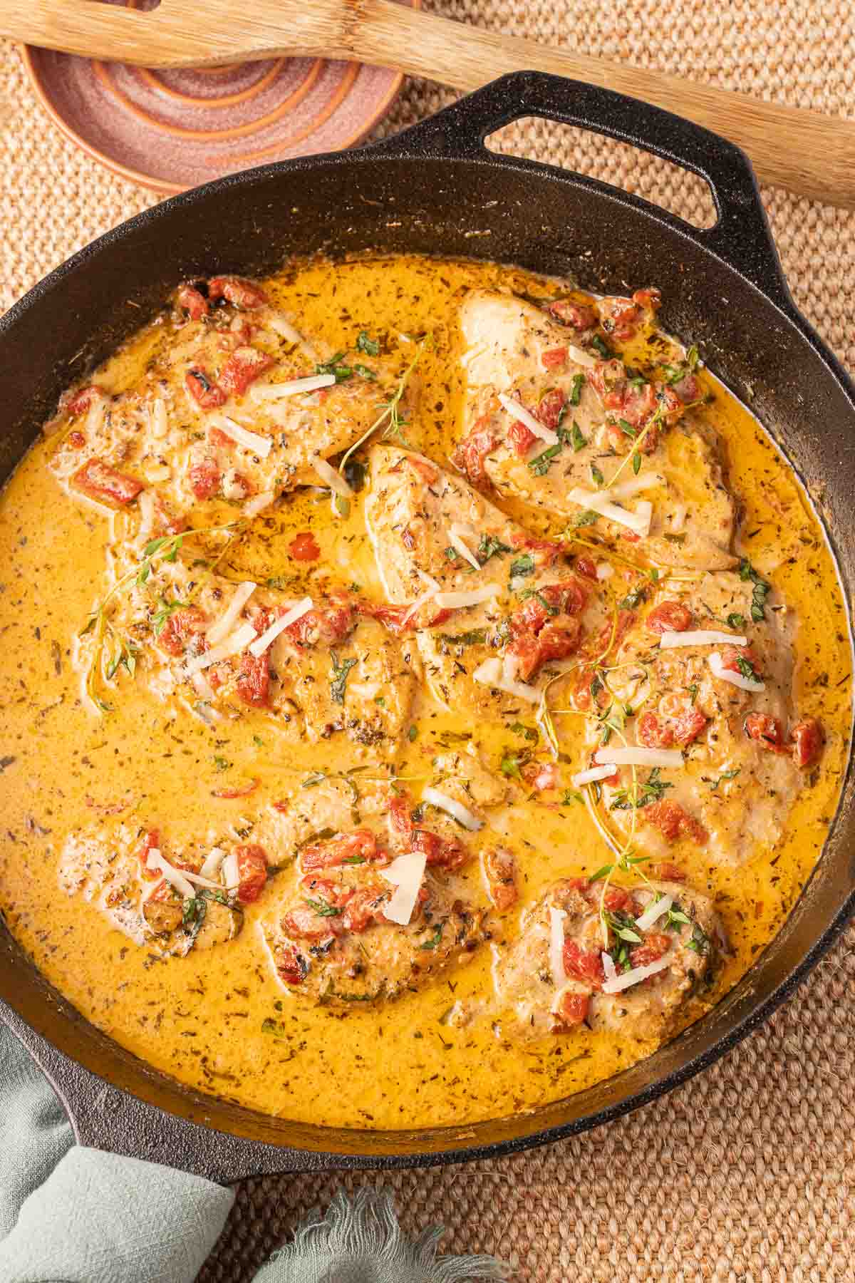 Cast iron skillet with browned boneless chicken.