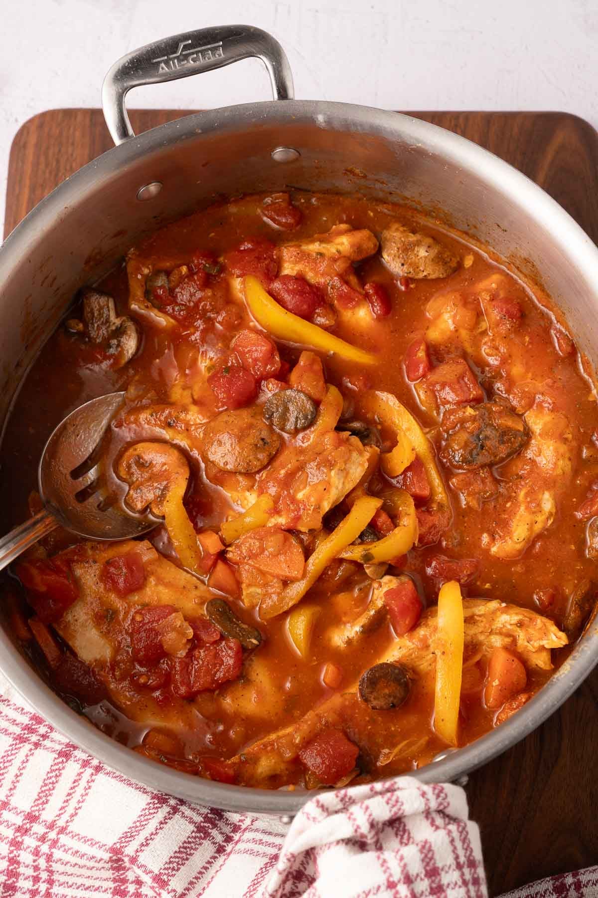 Chicken cacciatore simmering in skillet.